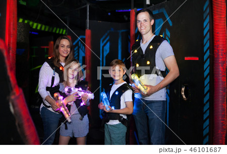 Parents and children playing laser tag Parents and children playing laser tag 46101687