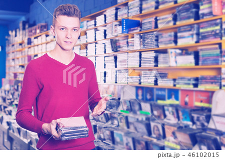 Guy holding CD in shop 46102015