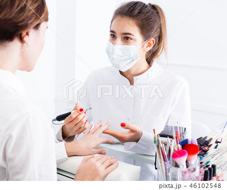 Woman doing shellac manicure Woman doing shellac manicure 46102548