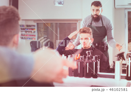 man client expressing dissatisfaction about his haircut at hair salon 46102581