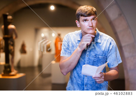 Man visiting museum with leaflet 46102883