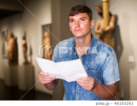 Man with brochure looking at exposition Man with brochure looking at exposition 46103261