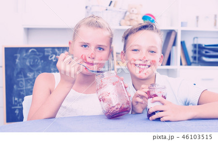 Portrait of sister with brother who are eating jam at time lunch 46103515