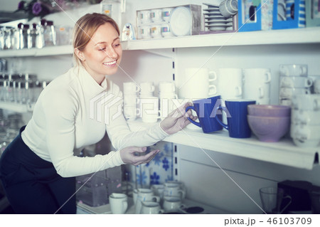 Woman choosing crockery in store Woman choosing crockery in store 46103709