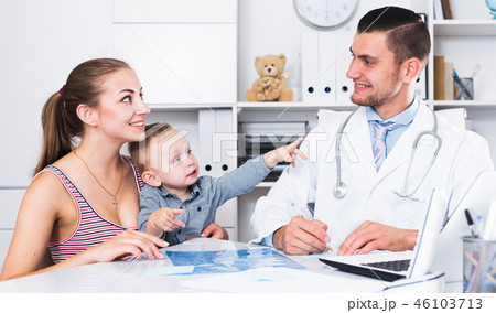 Man medical worker talking with young mother Man medical worker talking with young mother 46103713