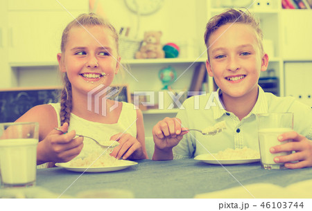 Portrait of sister with brother who are eating at time lunch Portrait of sister with brother who are eating at time lunch 46103744