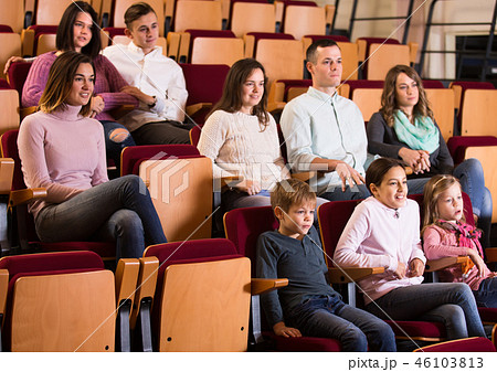 A group of people attentively watching a movie A group of people attentively watching a movie 46103813