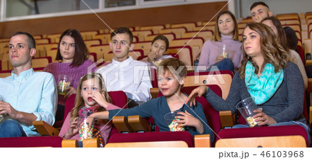 Number of people enjoying film screening and popcorn Number of people enjoying film screening and popcorn 46103968