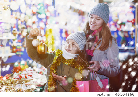 Young girl and her mother are choosing decorations for Christmas 46104266