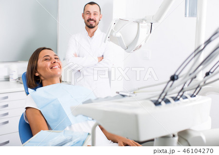 Girl is sitting satisfied after treatment in dental office 46104270