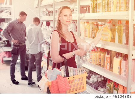 Woman choosing detergent at supermarket 46104308
