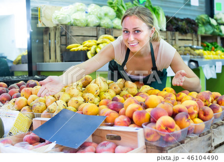 young woman selling fruits at market . young woman selling fruits at market . 46104490