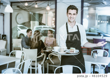 Waiter is warmly welcoming guests Waiter is warmly welcoming guests 46104529