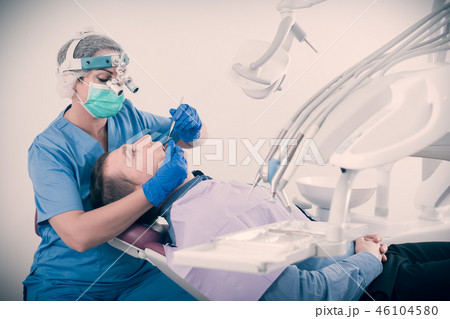 adult dentist checking teeth of patient adult dentist checking teeth of patient 46104580