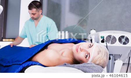 Woman receiving professional hardware body treatment in clinic Woman receiving professional hardware body treatment in clinic 46104615