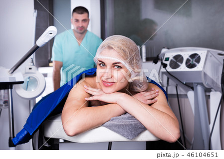 Woman getting cosmetological body procedure Woman getting cosmetological body procedure 46104651