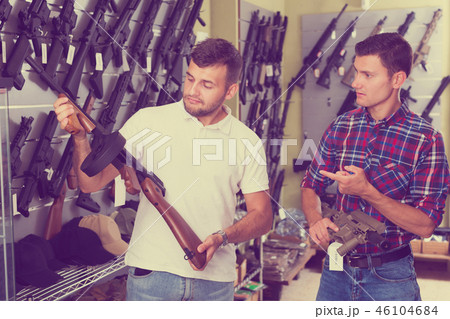 Friends choosing air-powered gun 46104684