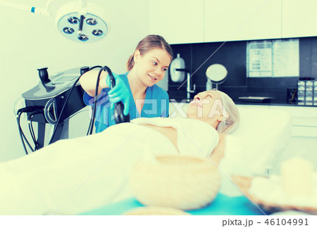 Cosmetician performing hardware body treatment 46104991