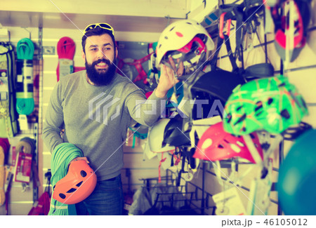 Man deciding on new helmet 46105012