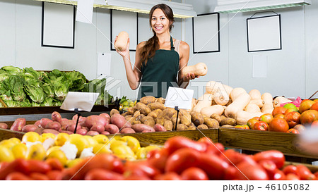 Woman in apron selling small decorative pumpkins Woman in apron selling small decorative pumpkins 46105082