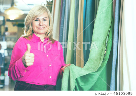 seller showing curtain and holding thumb up seller showing curtain and holding thumb up 46105099