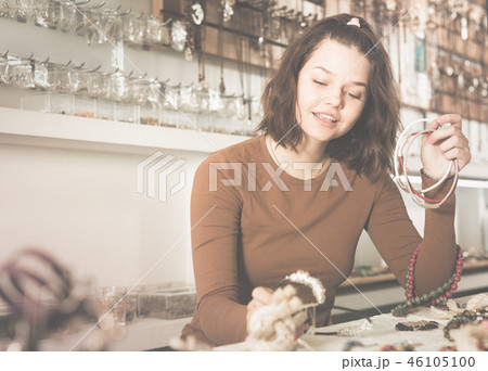 Woman showing different pendant 46105100