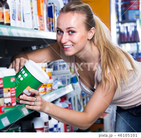 woman choosing paint bucket 46105101