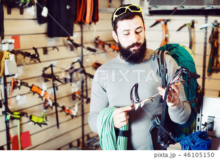 Man choosing climbing equipment Man choosing climbing equipment 46105150