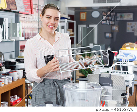 Female buyer choosing kitchen rack in the tableware store Female buyer choosing kitchen rack in the tableware store 46105776