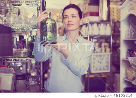 woman chooses glass decorative bottles woman chooses glass decorative bottles 46105814