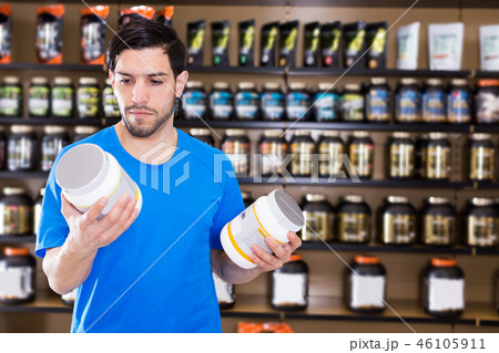 sport man looking different sport nutrition products 46105911