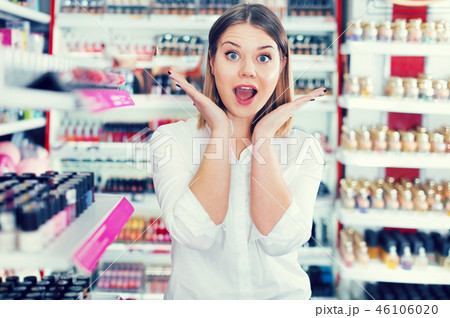 Woman delighted with assortment of cosmetics store Woman delighted with assortment of cosmetics store 46106020