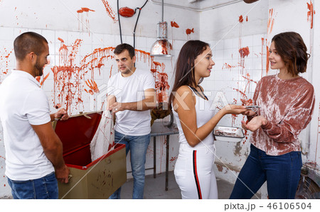 Young adults in escape room with traces of blood 46106504
