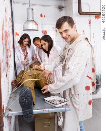 Guy with mad look over zombie mannequin Guy with mad look over zombie mannequin 46106520