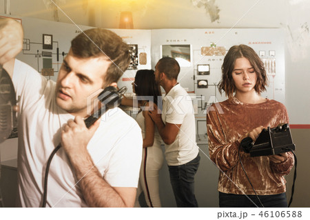 Young people with old telephone in lost room-bunker Young people with old telephone in lost room-bunker 46106588