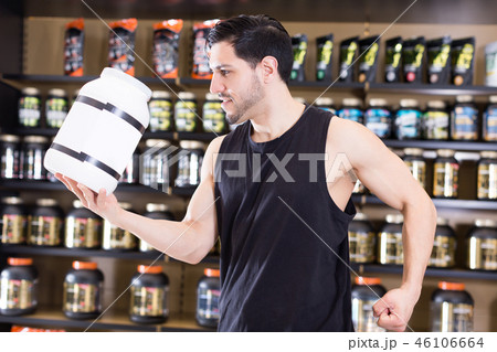 man showing muscles and sport nutrition man showing muscles and sport nutrition 46106664