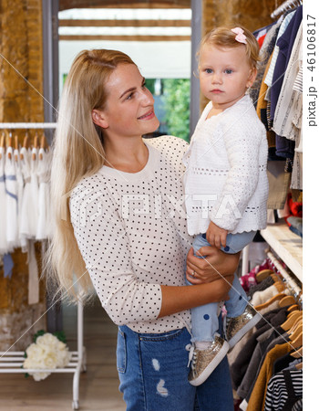 Mother and daughter choosing baby clothes Mother and daughter choosing baby clothes 46106817