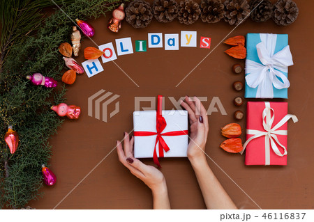 women's hands Christmas new year tree decoration holiday gifts background winter women's hands Christmas new year tree decoration holiday gifts background winter 46116837