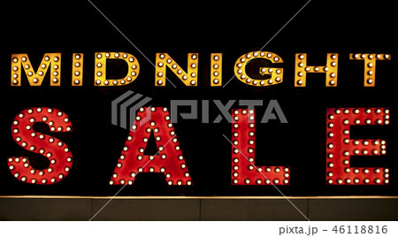 Midnight sale background. Brightly colored vintage advertising sign board with illumination Midnight sale background. Brightly colored vintage advertising sign board with illumination 46118816