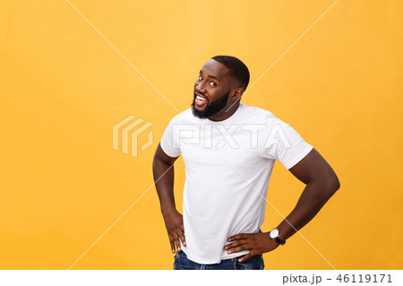 Portrait of handsome young african guy smiling in white t-shirt on yellow background 46119171