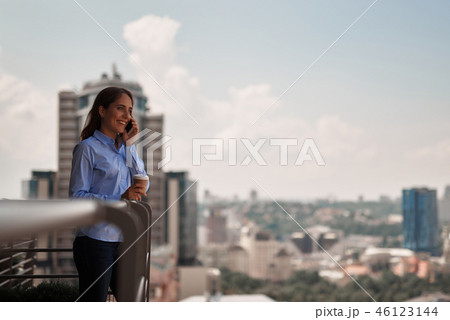 Young office woman talking by phone outdoors Young office woman talking by phone outdoors 46123144