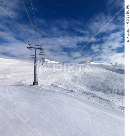 Ski slope, chair-lift on ski resort and blue sky 46126696