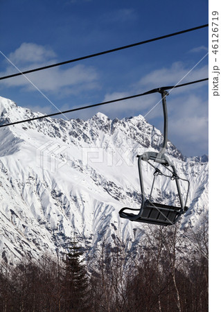 Ski-lift on ski resort and snowy mountains Ski-lift on ski resort and snowy mountains 46126719