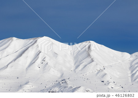 Snowy winter mountains and blue clear sky 46126802