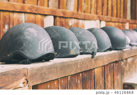 horse helmets in a line waiting to be used 46126868
