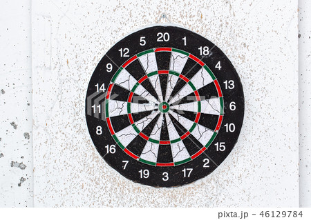 Empty old target dart board. Old used colorful board with lot of shots close up outdoors 46129784