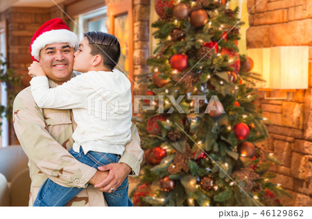 Hispanic Armed Forces Soldier Wearing Santa Hat Hugging Son In F Hispanic Armed Forces Soldier Wearing Santa Hat Hugging Son In F 46129862