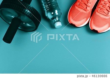 Living Coral sneakers on blue background. 46130666