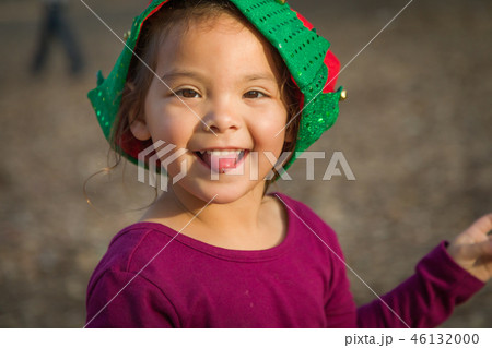 Mixed Race Toddler Girl Wearing a Christmas Hat Mixed Race Toddler Girl Wearing a Christmas Hat 46132000