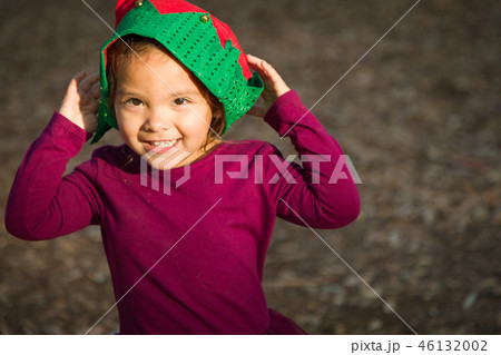 Mixed Race Toddler Girl Wearing a Christmas Hat Mixed Race Toddler Girl Wearing a Christmas Hat 46132002